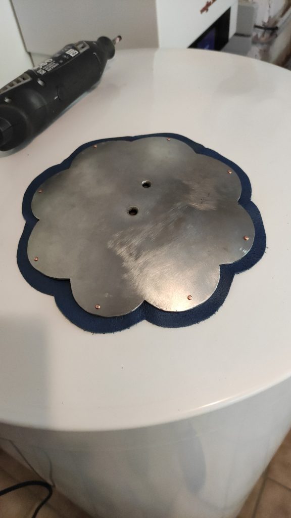 A flower shaped roundel Spaulder on blue leather