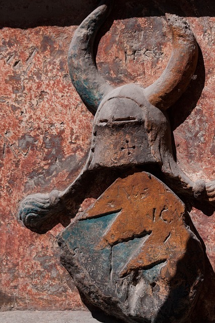 a coat of arms with horned helmet carved in stone