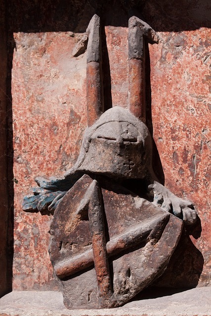 a coat of arms with crossed harpoons carved in stone